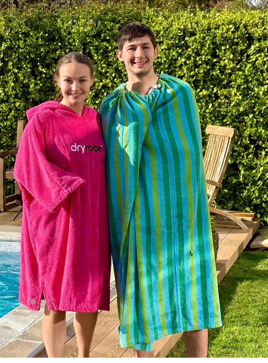 Pink and green robes by the pool
